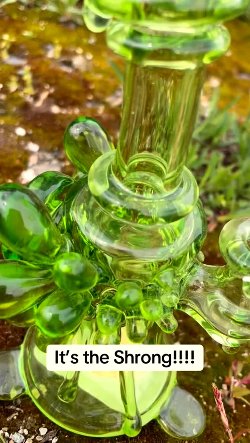 Green glass piece held to the light